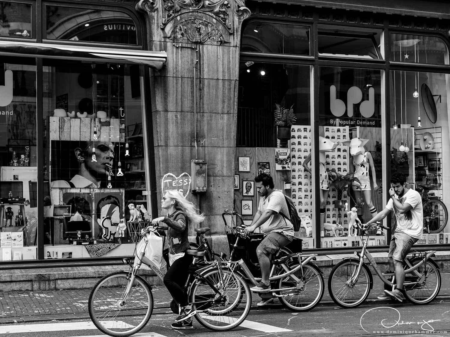 Menschen mit Fahrr&auml;dern an einer Ampel in Amsterdam von Fotograf Dominique Hammer